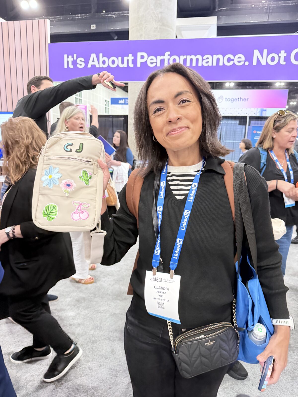 Event guest showing off her personalized patch tote bag