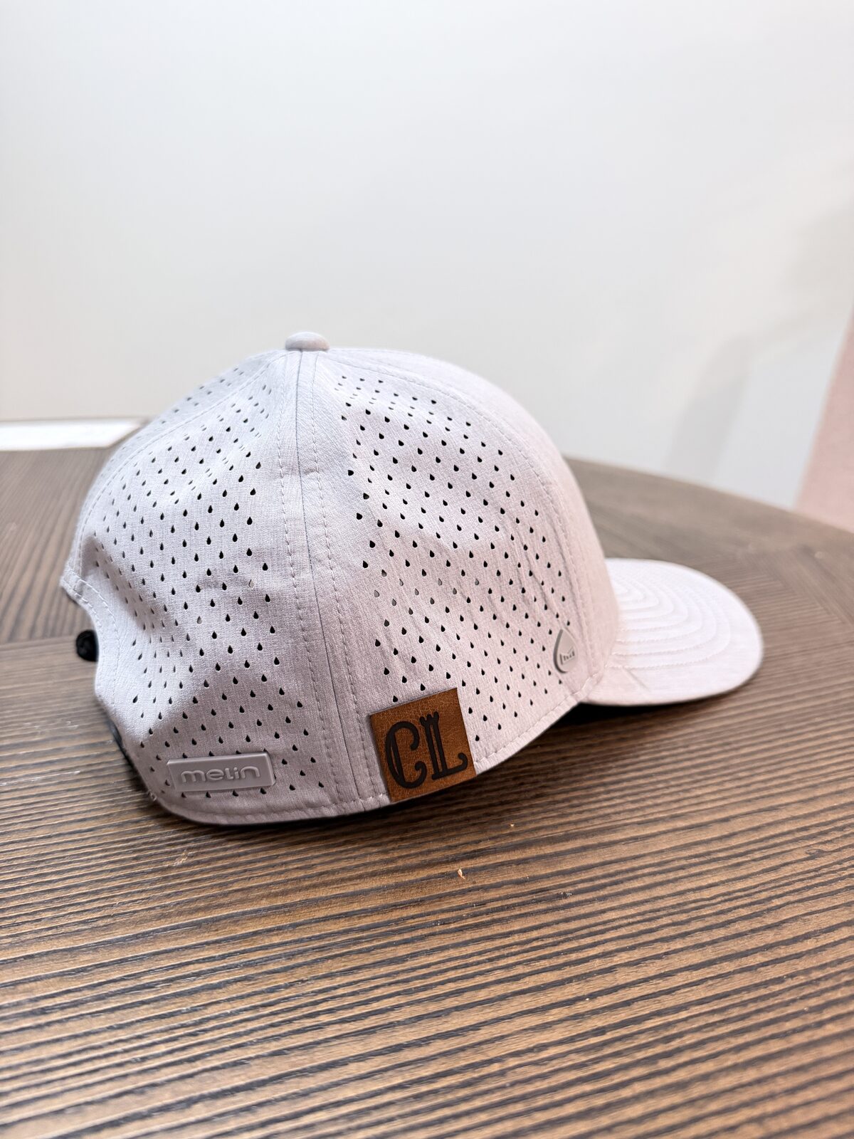 Custom leather patch heat-applied to a Richardson 112 cap at an event